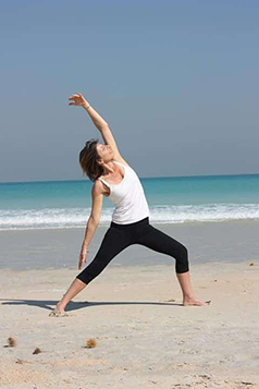 woman stretching her body in the beach